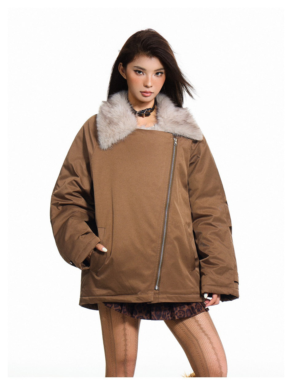 Model wearing a brown oversized jacket with a pale fur collar, asymmetrical zipper and front pockets.