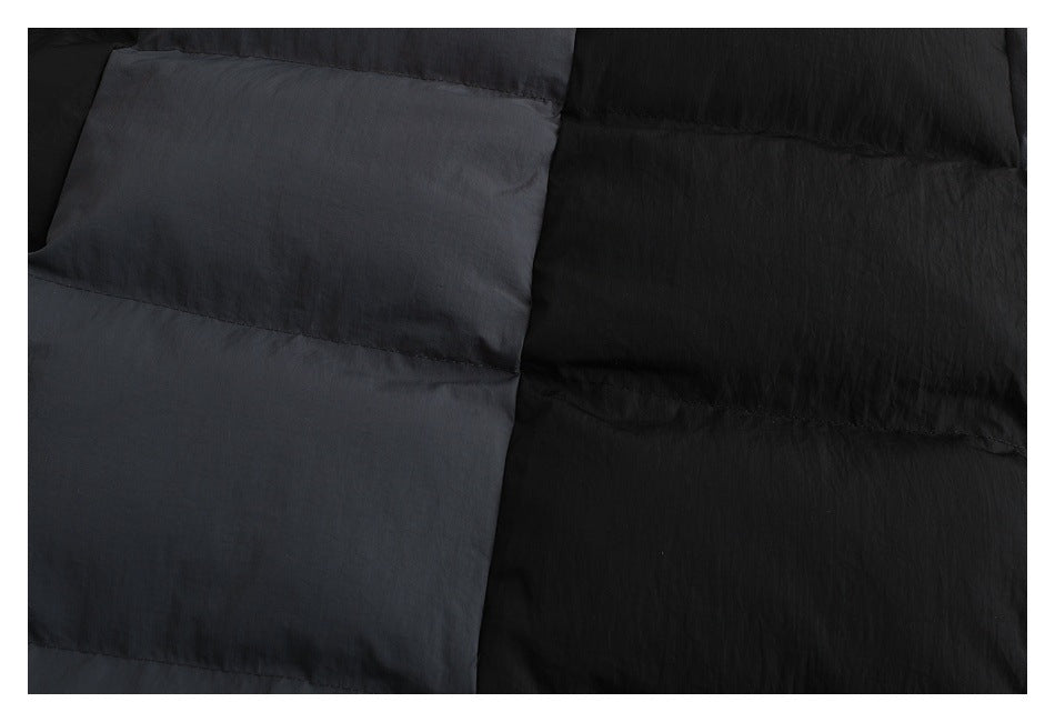 Close-up showing the black and charcoal jacket’s quilted panels and fabric texture.