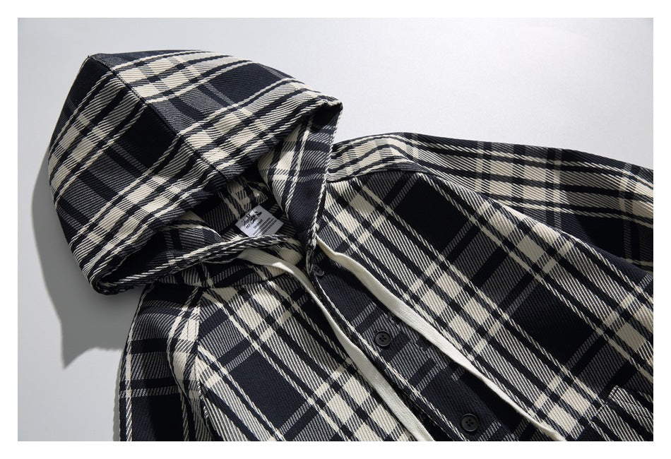 Angled close-up of the plaid hood and upper front, showing the button placket and a small inside label.