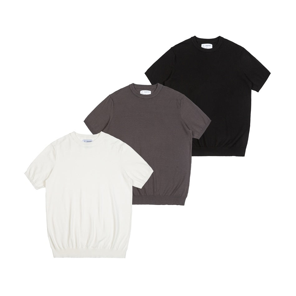 Three short-sleeve knit tops arranged together in cream, taupe and black, shown from the front.