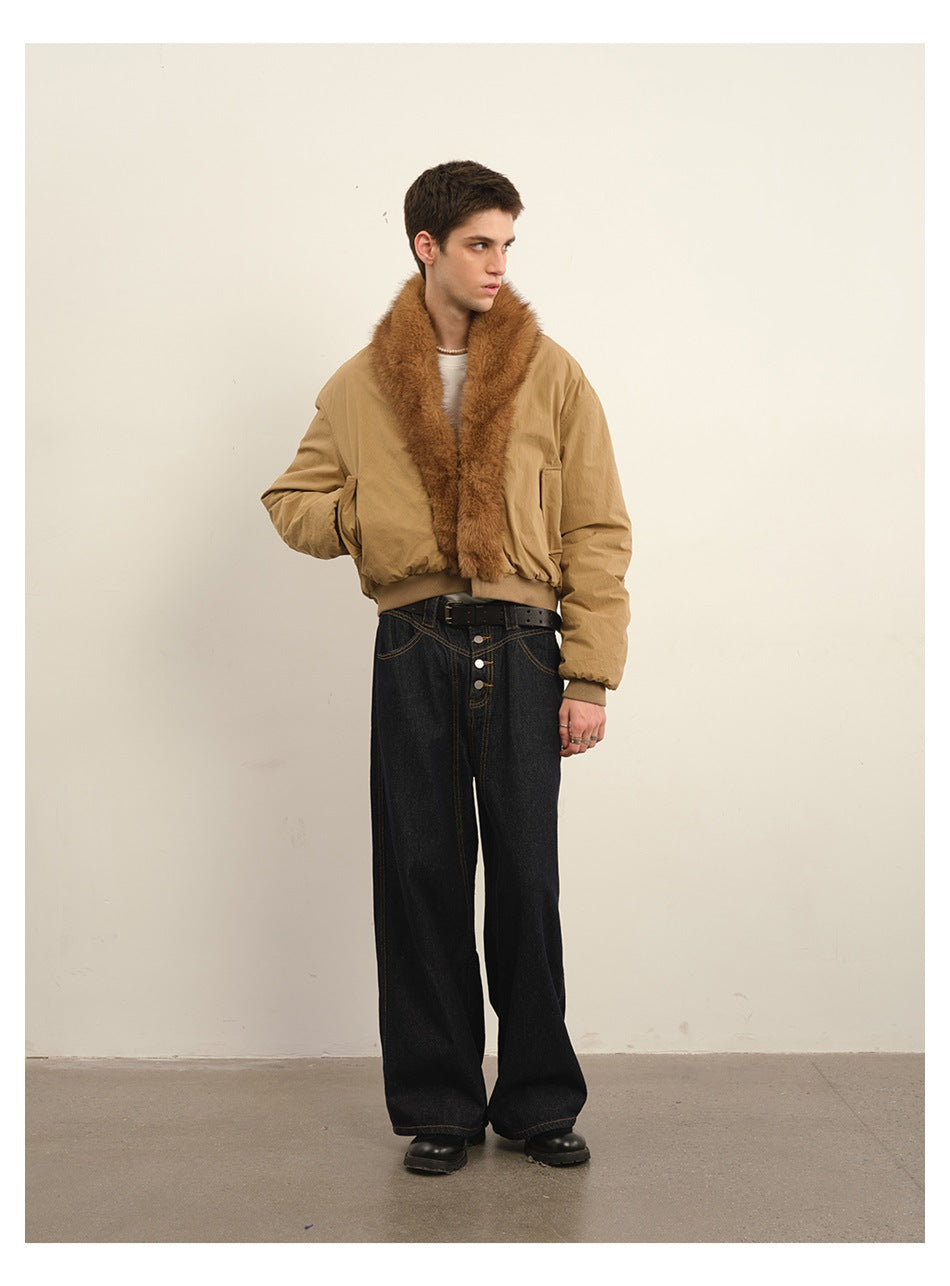 Model wearing a tan bomber jacket with a wide brown plush collar and black wide-leg jeans, full-length view.