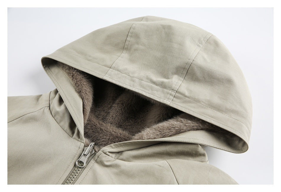 Close-up of a pale beige jacket hood with brown plush lining and a front zipper.