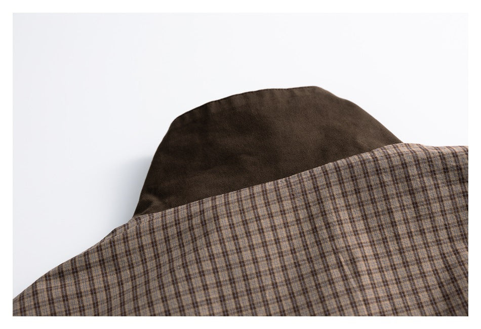 Close-up of brown plaid fabric overlapping a solid dark-brown panel.