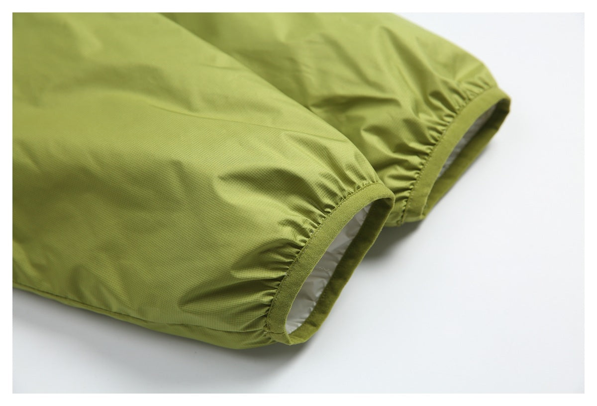 Close-up of two gathered lime-green sleeve cuffs with narrow bound edges.