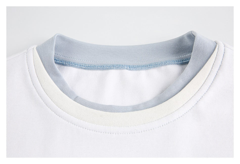 Close-up of a white shirt’s round neckline, showing pale blue inner ribbing and stitched collar bands.