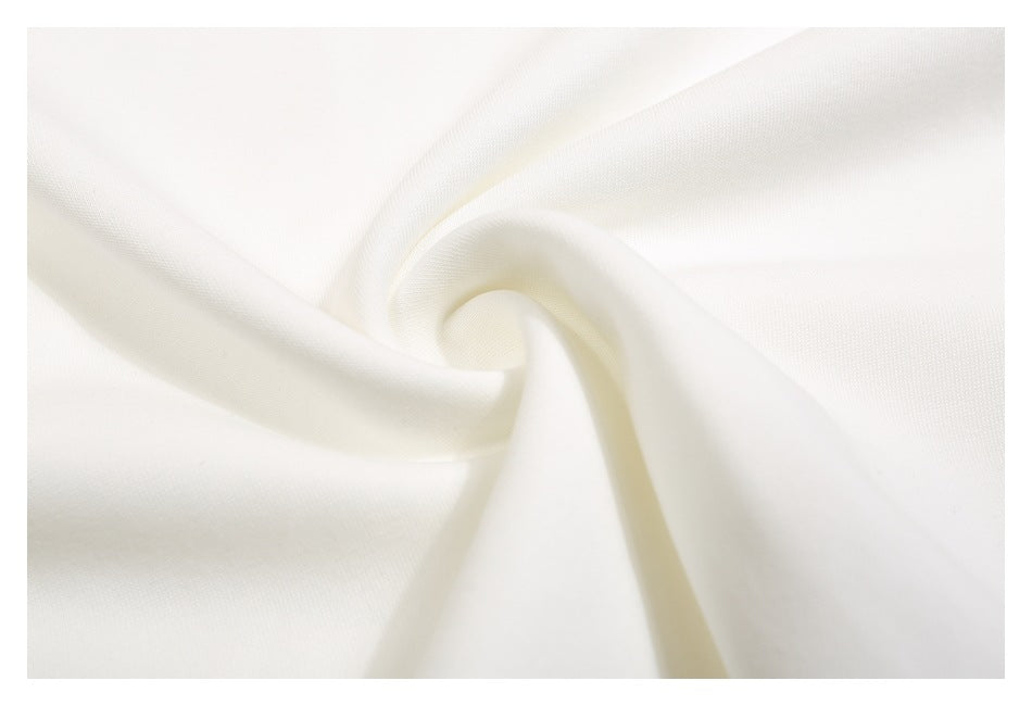 Close-up of smooth white fabric gathered into a spiral fold.