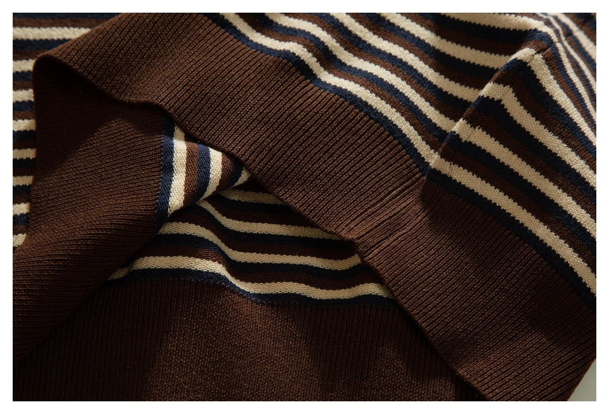 Close-up of a wide brown ribbed cuff against cream, navy, and brown stripes.