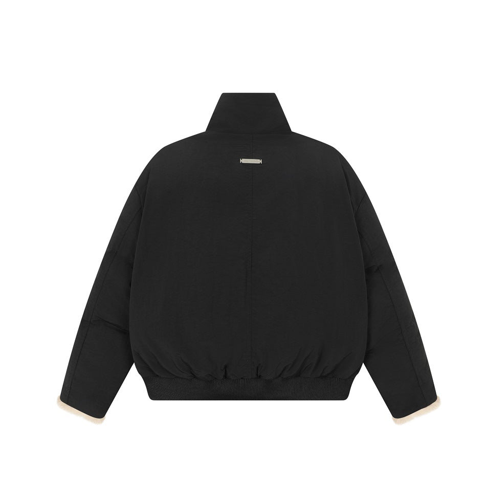 Back view of a black oversized jacket with a high collar, long sleeves, and ribbed hem.