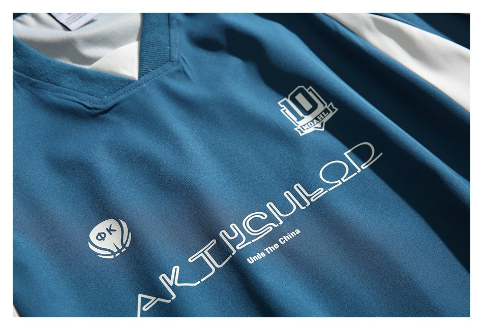 Close-up of white logos and lettering printed on the blue pullover's chest.