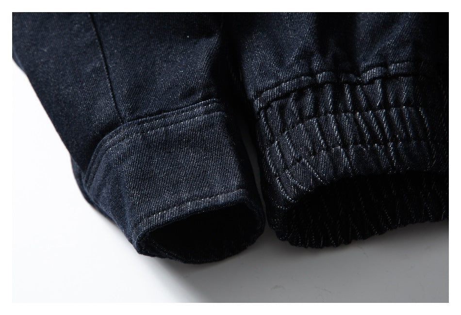 Close-up of a dark indigo jacket sleeve cuff beside its gathered elastic hem.