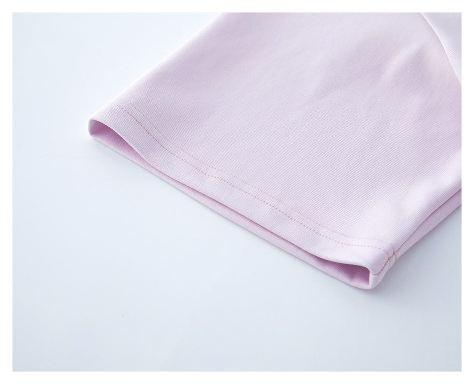 Close-up of the pale pink T-shirt sleeve opening with double-row stitching.