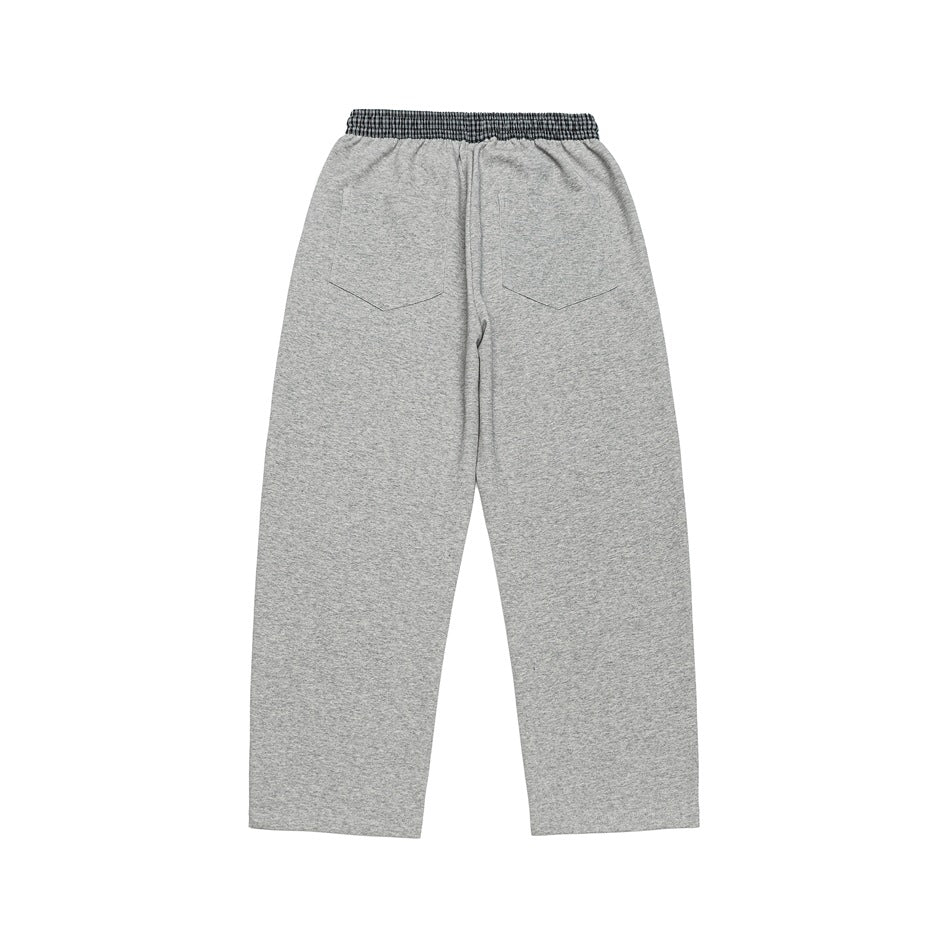 Back view of light gray wide-leg pants with two rear pockets and a checked waistband.