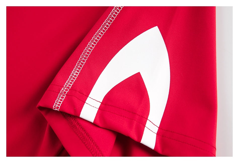 Close-up of a red garment sleeve hem with white overlock stitching and a large white graphic.