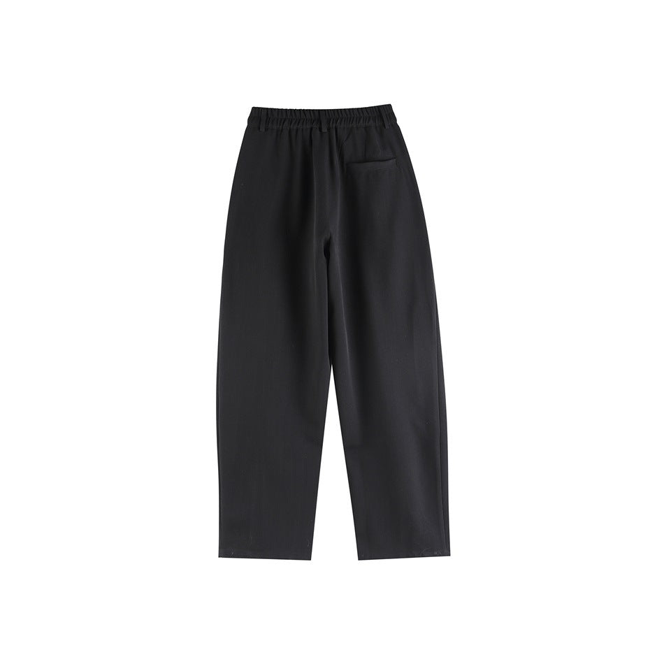 Black wide-leg trousers back view with elastic waistband and a single back welt pocket, flat lay