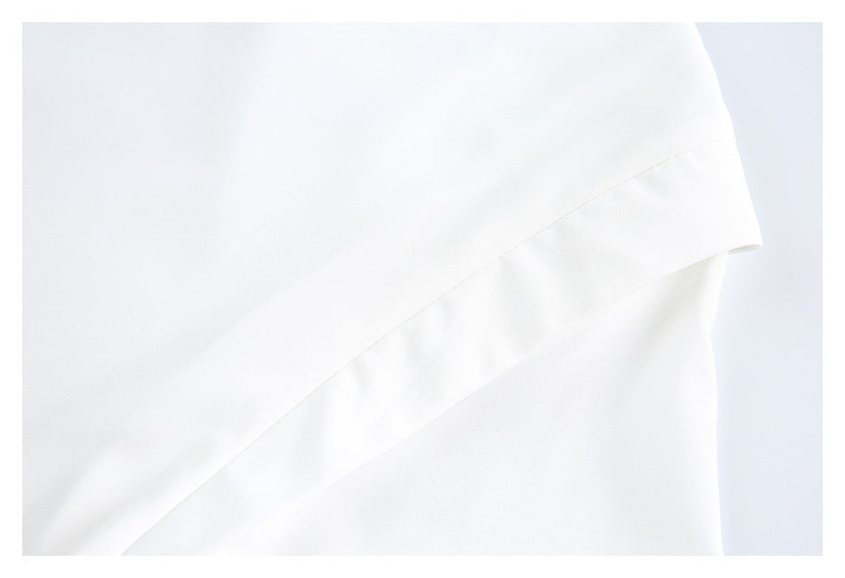 Close-up of a white sleeve edge with a wide stitched cuff band.