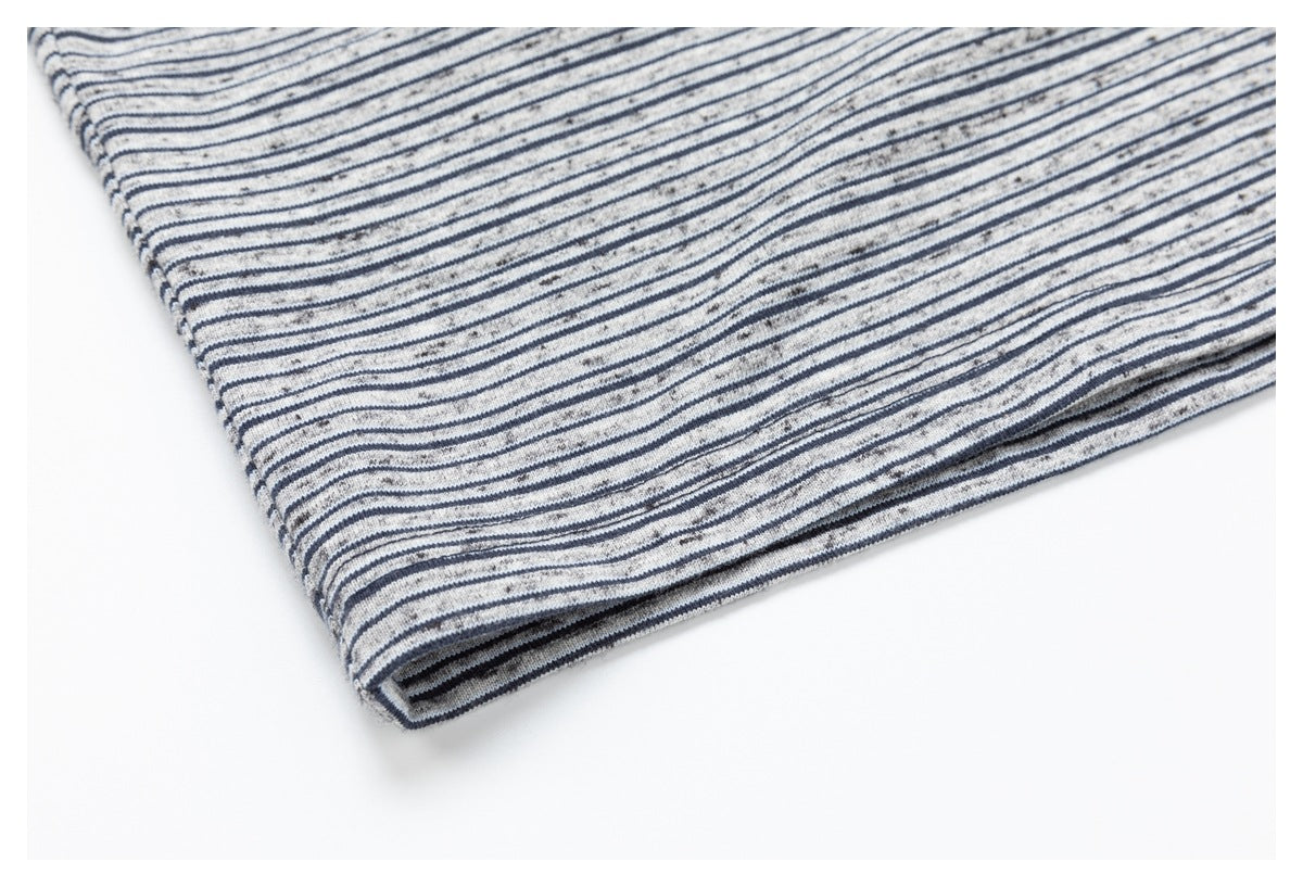 Close-up of the striped fabric and folded hem of the top.