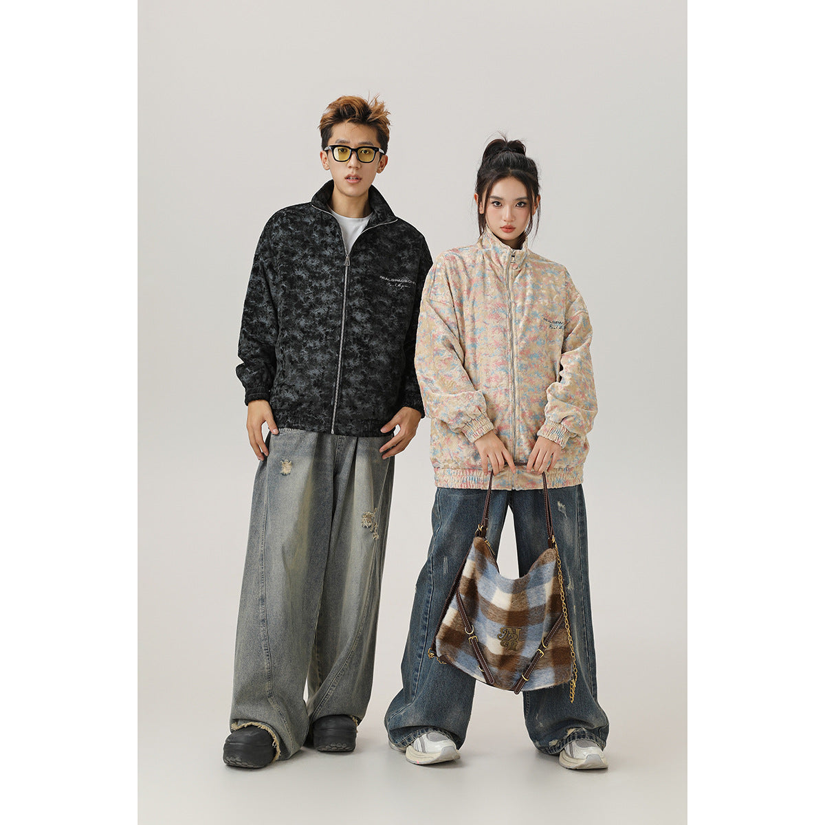 Two models wear zip-up jackets: one black mottled style and one pastel multicolor style.