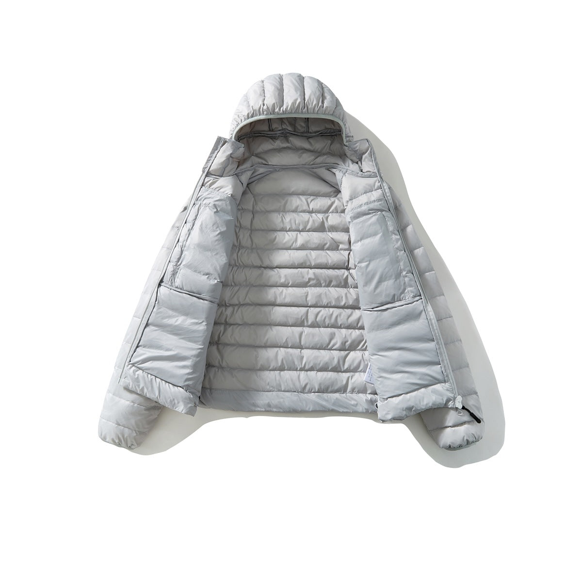 Light gray hooded puffer jacket laid flat and unzipped, showing the quilted lining and front panels.