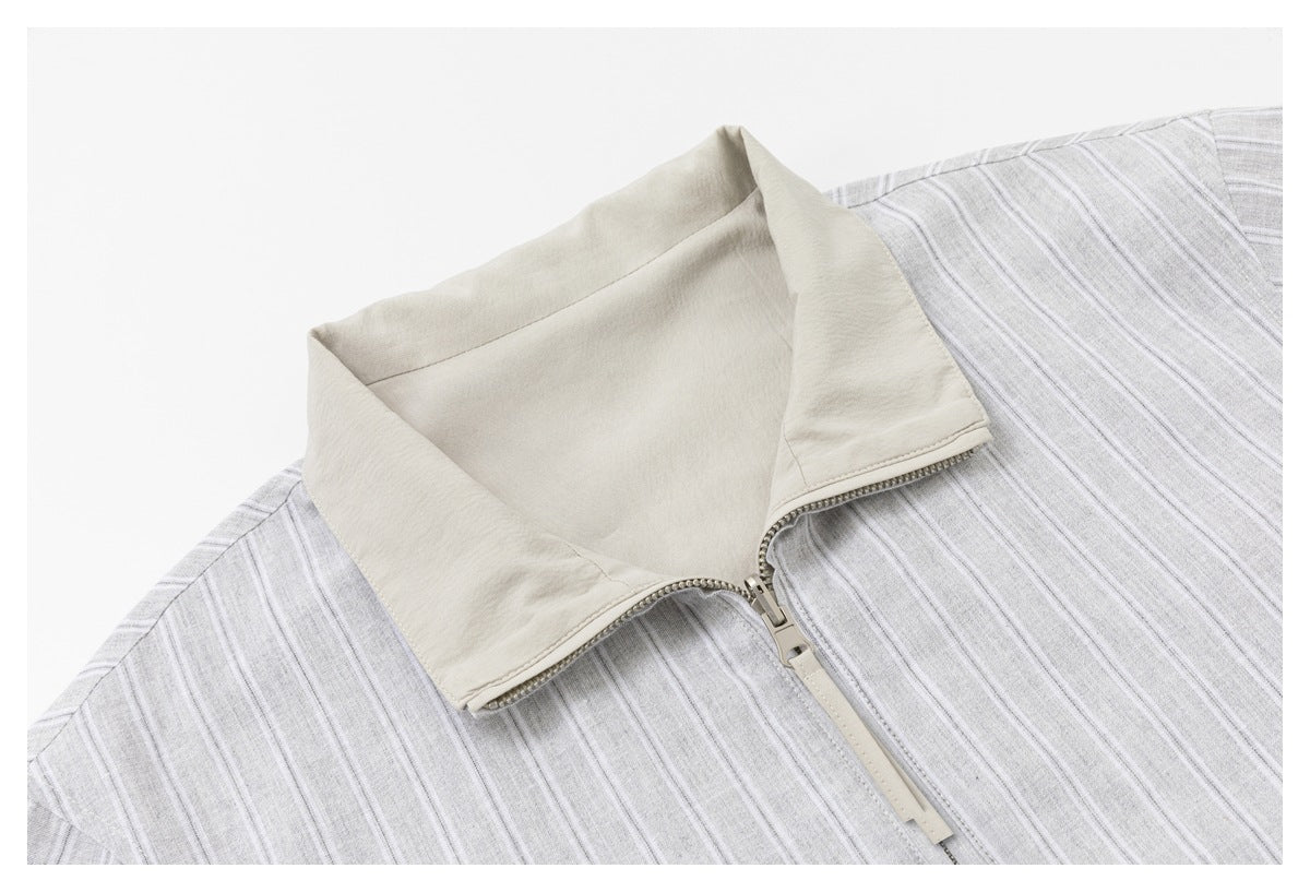 Close-up of the jacket's open stand collar, pale lining, and zipper.