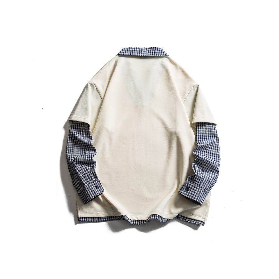 Back view of a cream short-sleeve top layered over blue-and-white plaid sleeves, collar, and hem.
