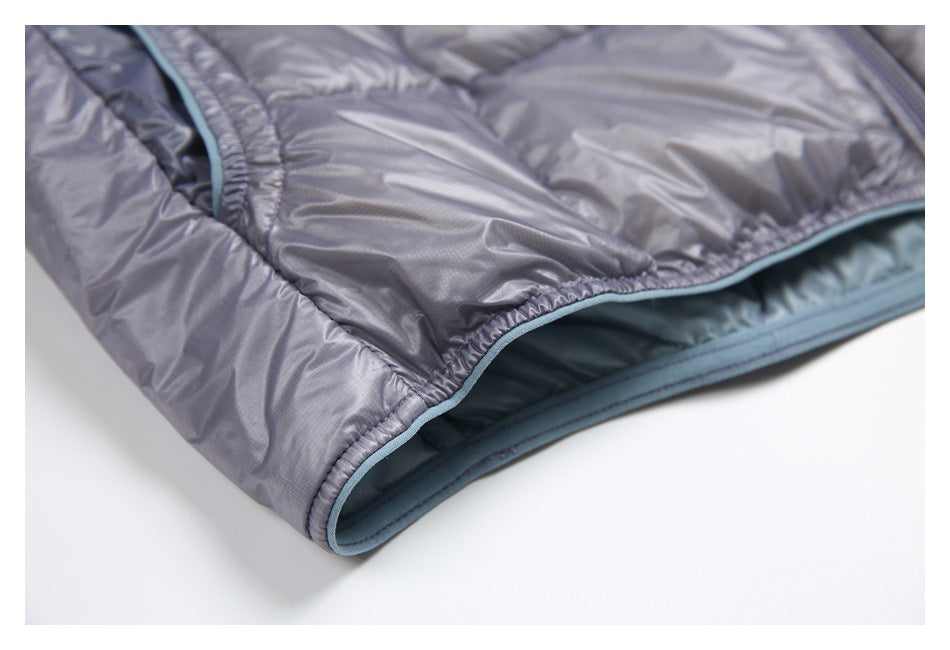 Close-up of the gray jacket hem showing pale blue edging and blue-gray inner lining.