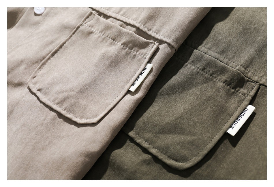 Close-up of two shirts in beige and olive, each showing a stitched chest pocket and a small sewn label.
