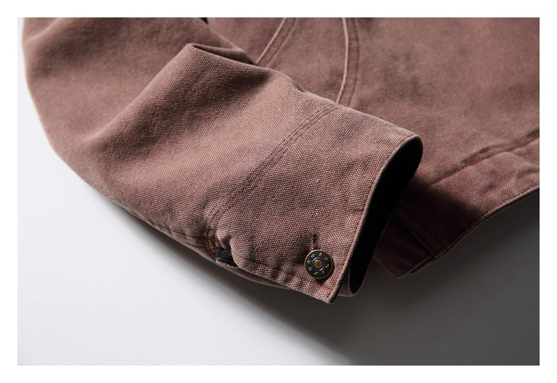 Close-up of the jacket sleeve cuff with a metal snap fastener and visible stitching.