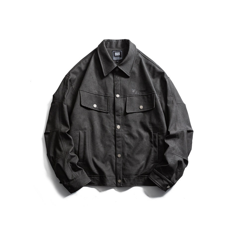 Black button-front jacket with pointed collar, chest flap pockets and snap cuffs, laid flat