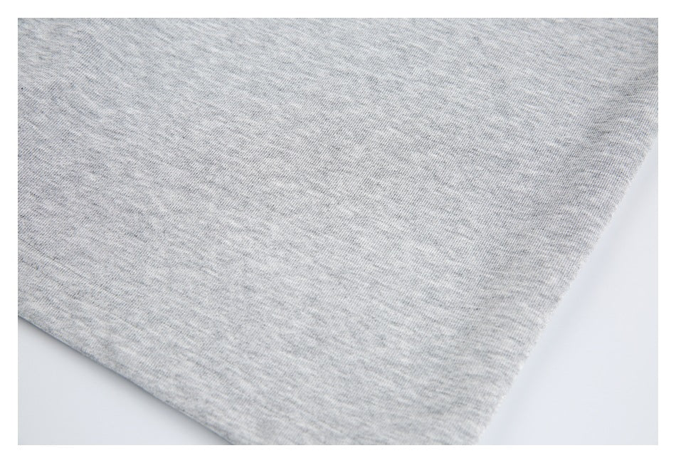 Close-up of a folded edge on the light gray garment.