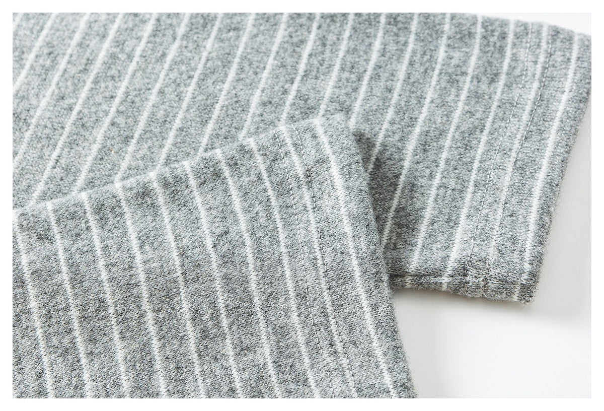 Close-up of the gray-and-white striped shirt sleeve and stitched cuff edge.