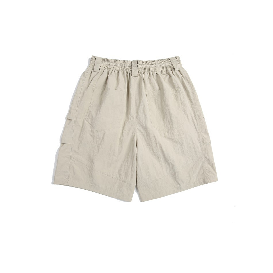 Back view of beige cargo shorts with an elastic waistband, belt loops, and two rear pockets.