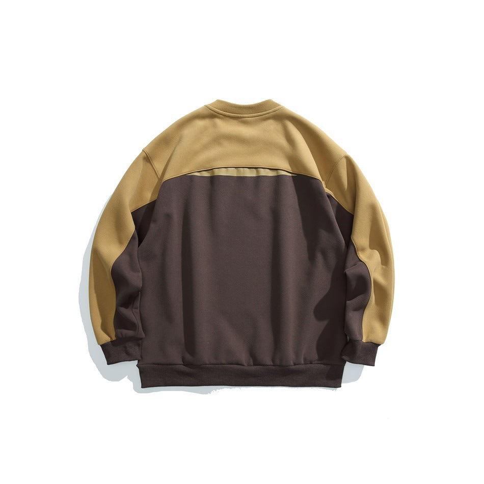 Back of a color-block crewneck sweatshirt, with a dark brown body and mustard sleeves and upper back.