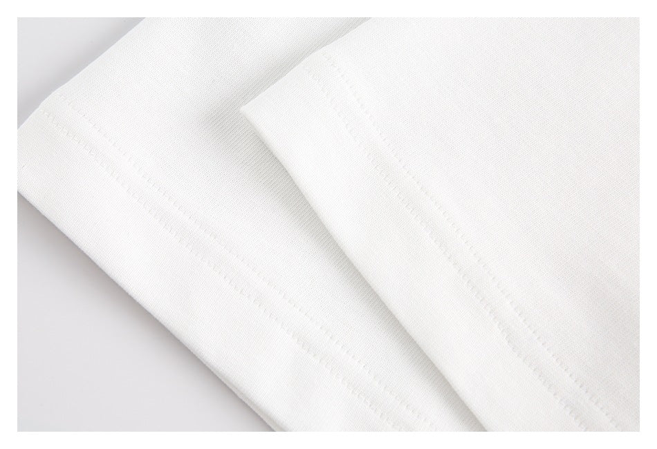 Close-up of white garment fabric with a folded edge and parallel stitching.