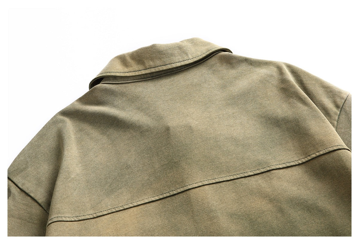 Close-up of the back of an olive-green shirt showing its collar and horizontal yoke seam.