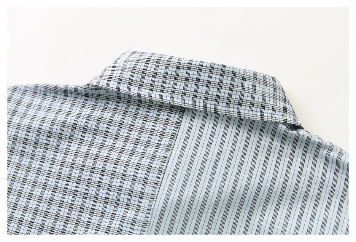 Close-up of the shirt collar, showing a black and pale blue plaid exterior and fine striped inner fabric.