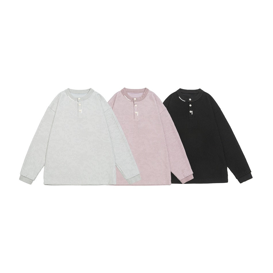 Three ribbed long-sleeve Henleys shown flat in light gray, pale mauve, and black.