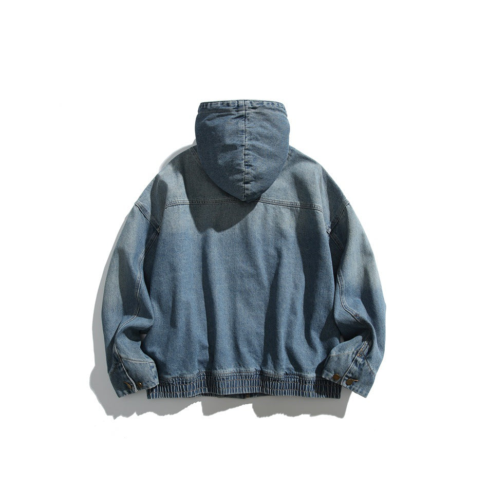 Back view of blue washed denim hooded jacket with yoke seam, ribbed hem and button cuffs