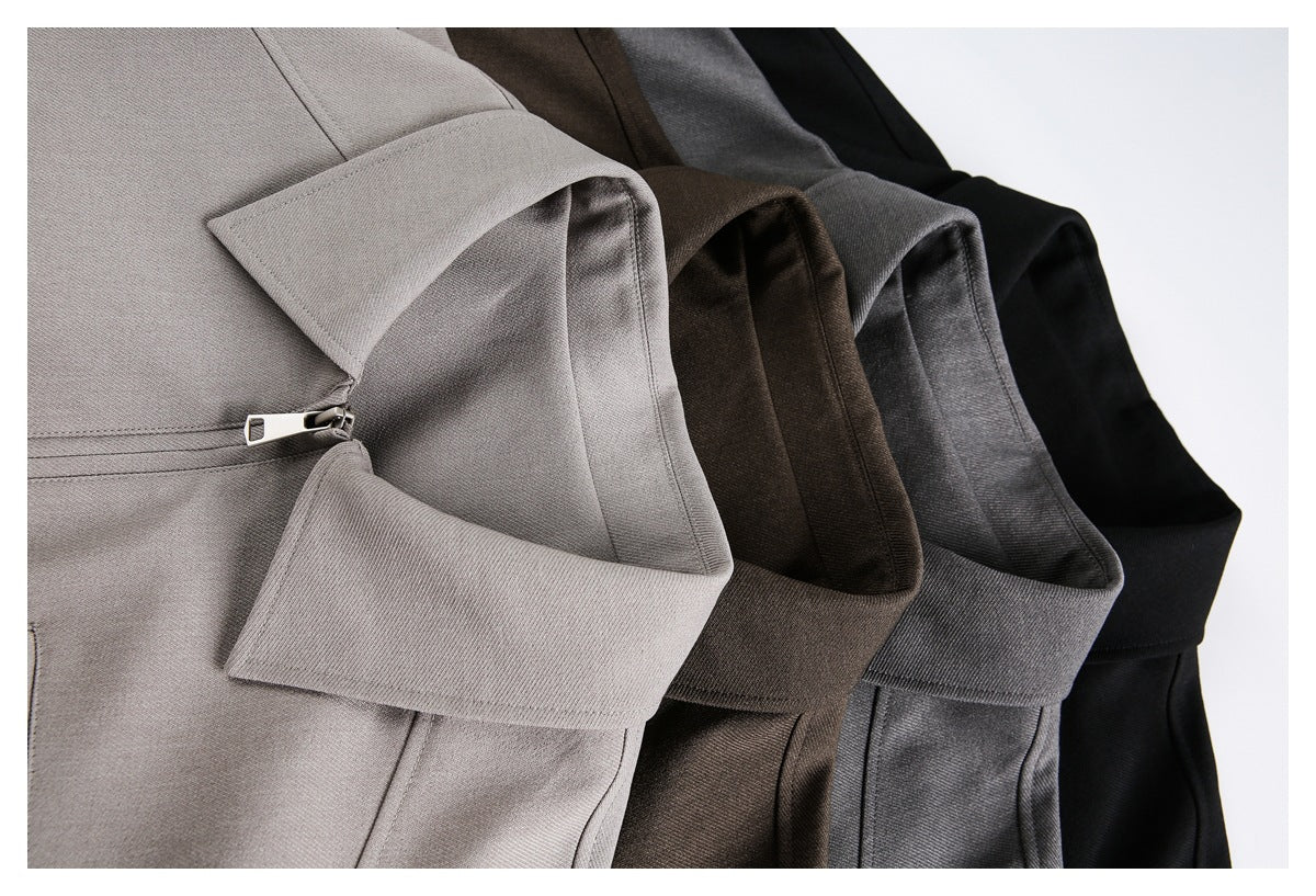 Close-up of taupe, brown, gray and black jackets arranged together, highlighting collars and front zippers.