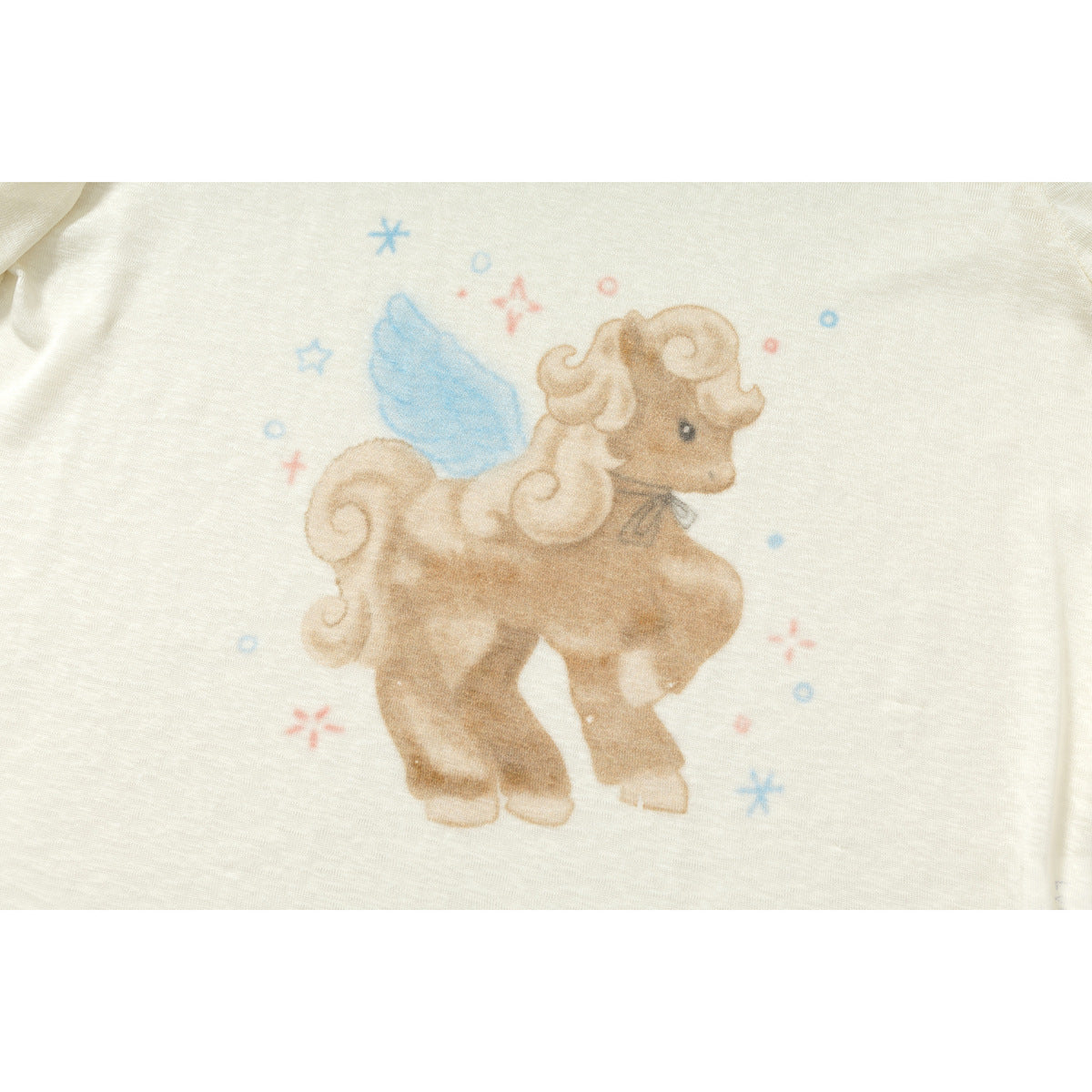 Close-up of a brown winged pony print with blue and coral accents on an ivory shirt.