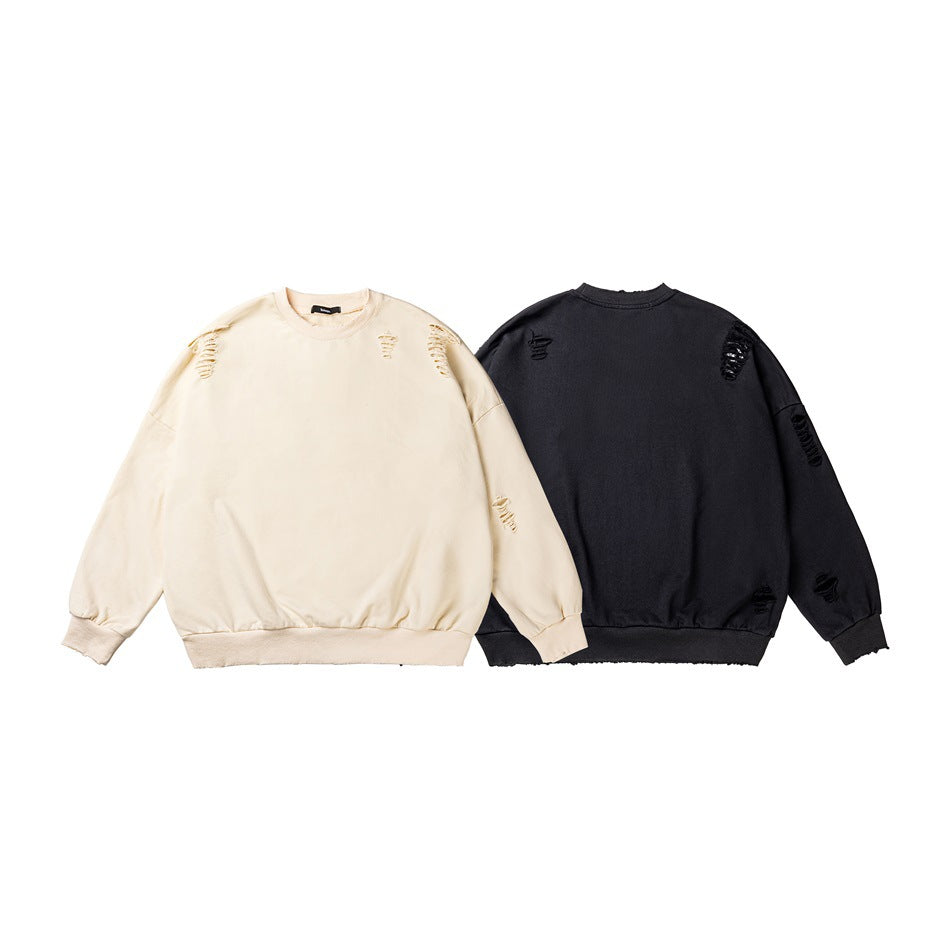 Cream front-view and charcoal back-view crewneck sweatshirts, each with scattered distressed details.