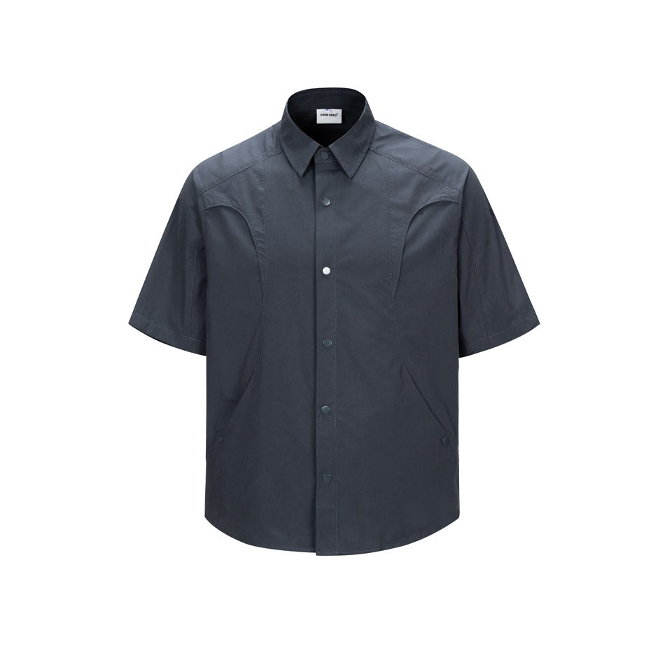 Dark navy short-sleeve button-up shirt with curved panel seams and snap buttons, front view