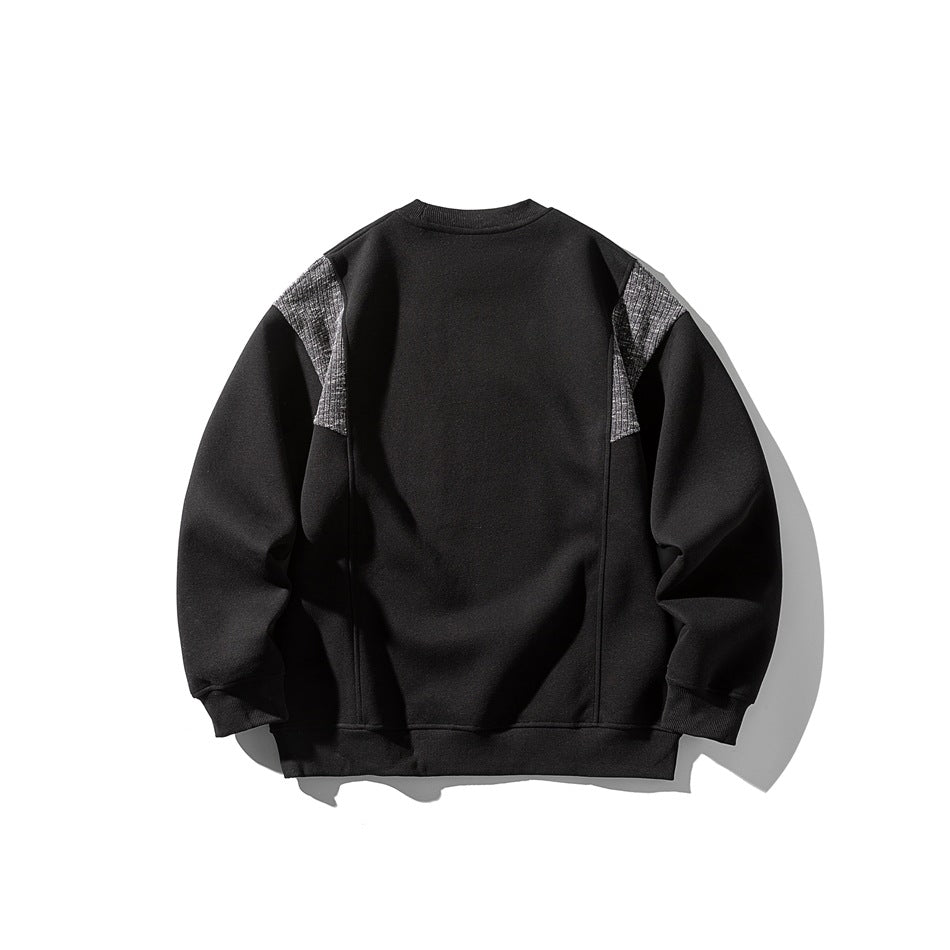 Back view of a black crewneck sweatshirt with gray textured shoulder panels, shown flat against a white background.
