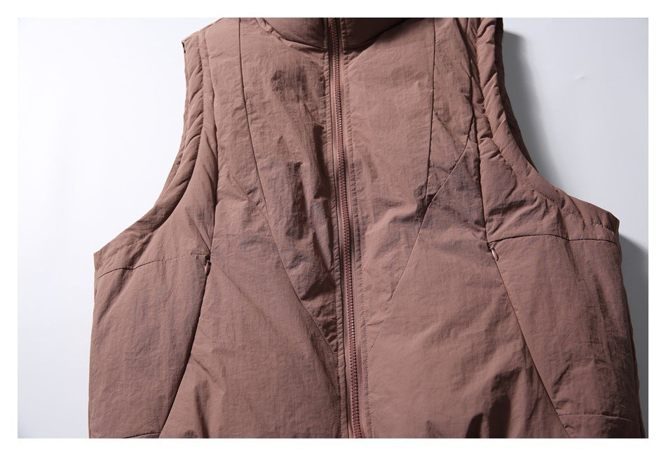 Front view of a dusty mauve sleeveless vest with a tall collar, center zipper, and curved panel seams.