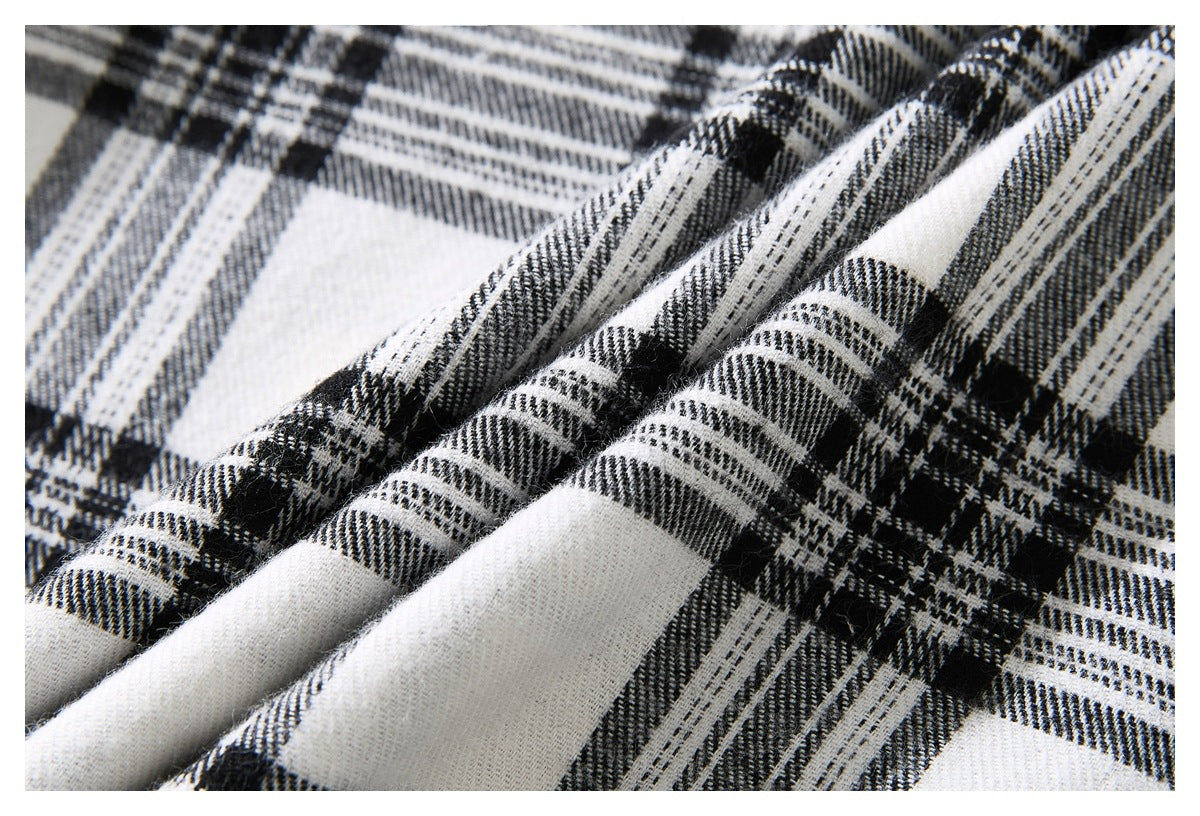 Close-up of the black-and-white plaid fabric, showing its woven check pattern and folds.
