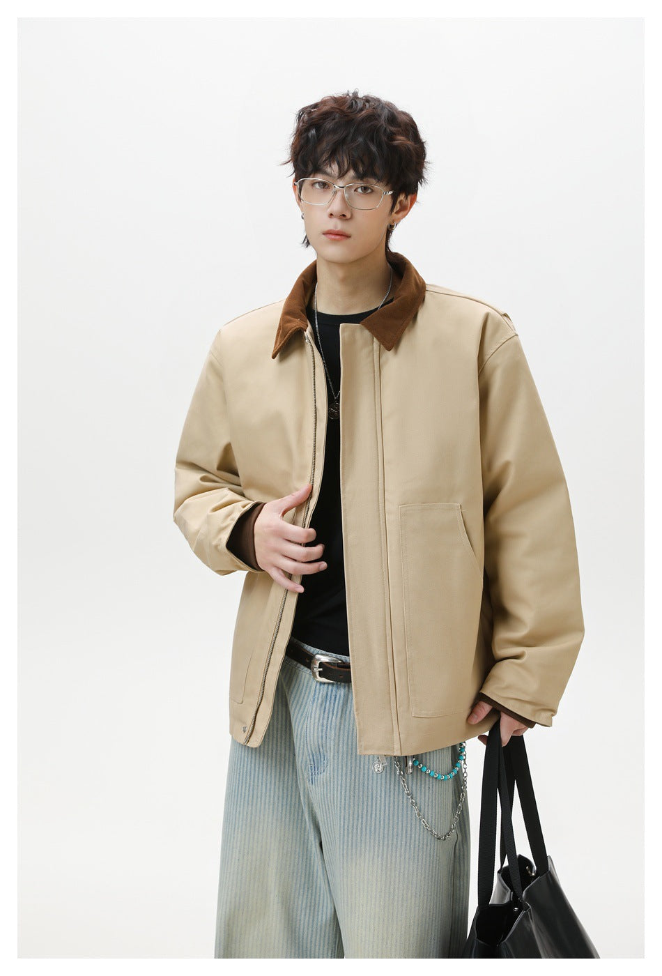 Model wearing an open beige jacket with a brown collar, front zipper and large patch pockets.
