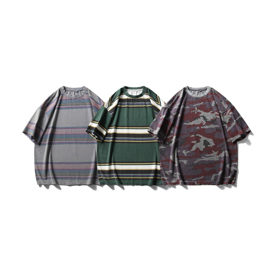 Three short-sleeve T-shirts shown together: gray striped, green striped and burgundy-gray camouflage.