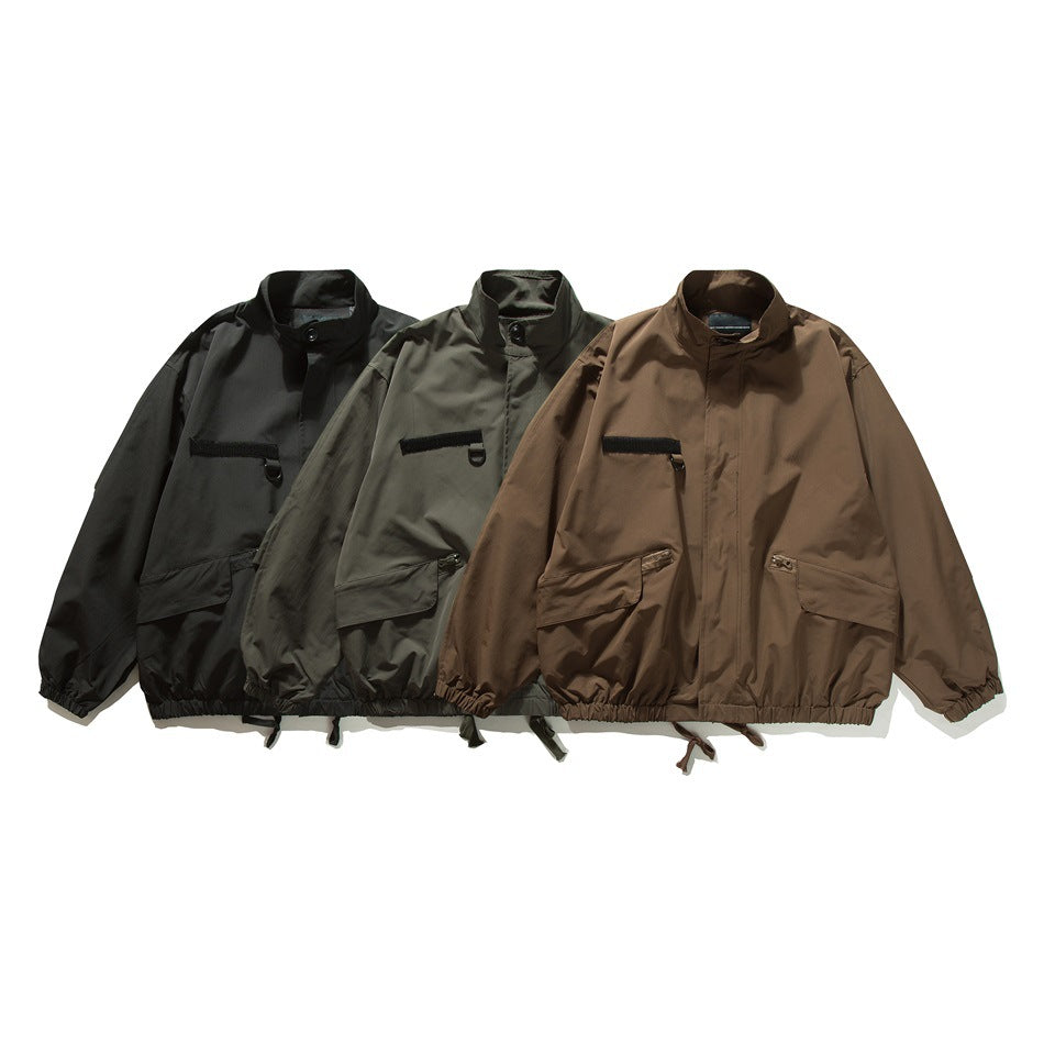 Three front-view jackets in black, dark gray, and brown, with stand collars and front pockets.