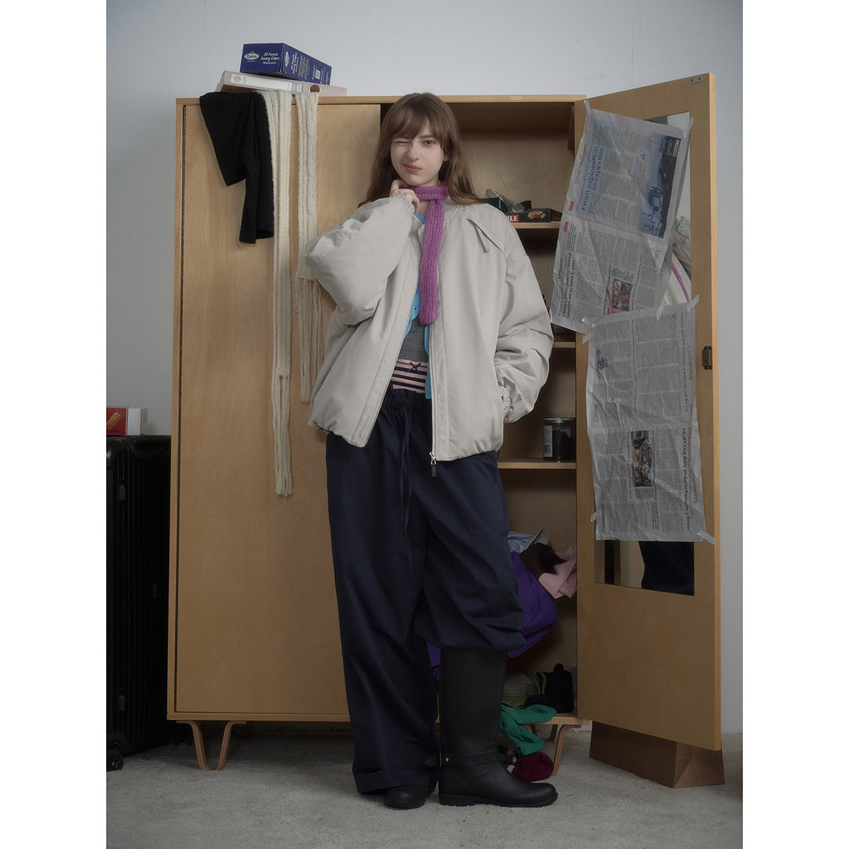 Full-length model wearing a light gray oversized bomber jacket with a front zipper and gathered cuffs.