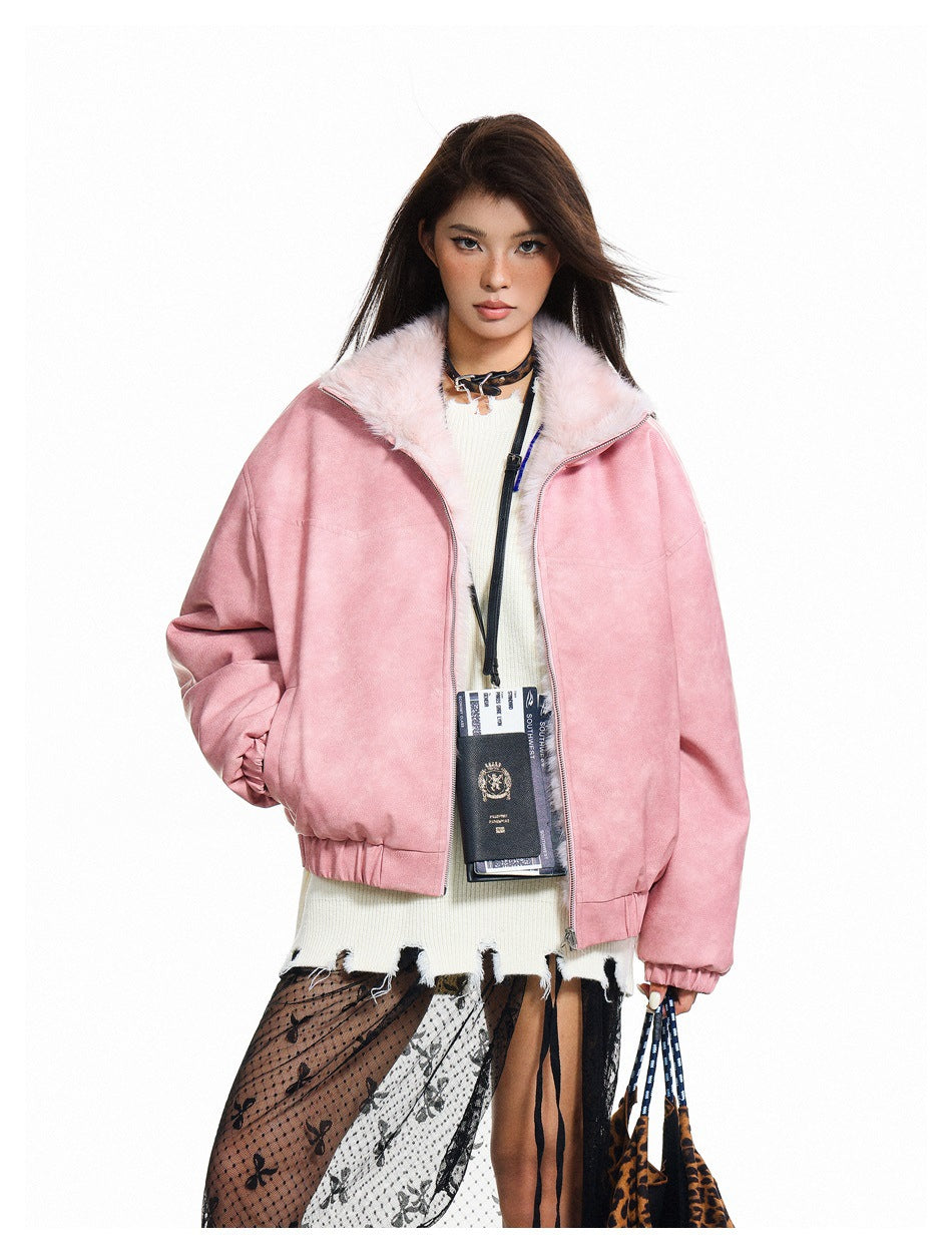 Model wearing an open dusty pink jacket with a pale plush collar and zip front.