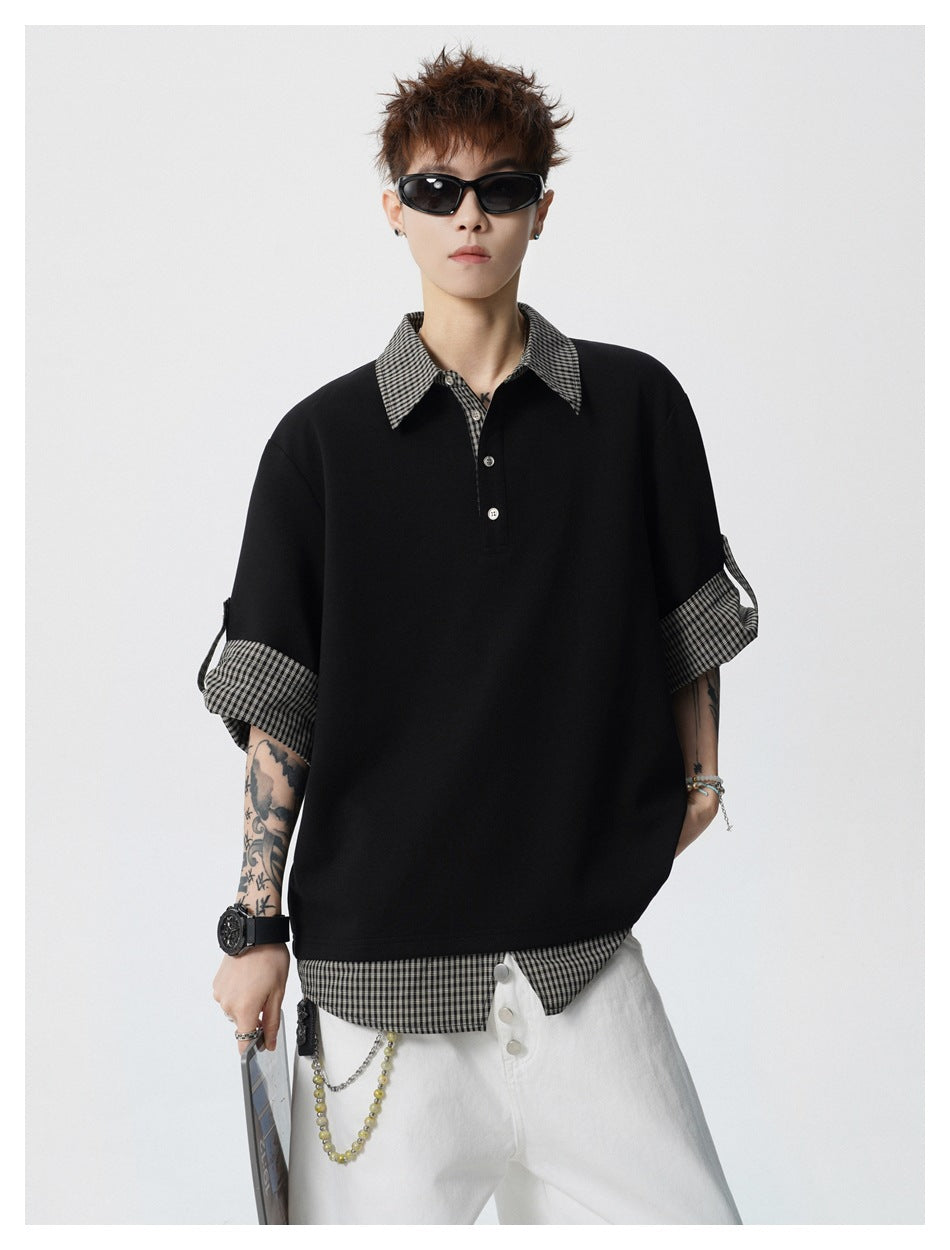 Model wearing black layered polo-style top with gingham collar and sleeves, white pants and sunglasses